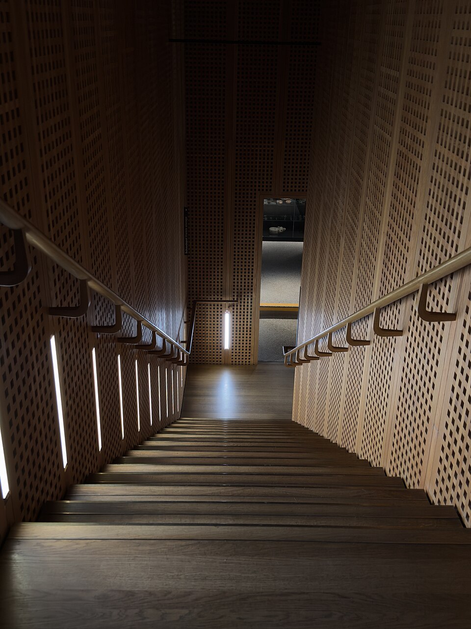 Stair-side linear wall lighting at Museum Rietberg, Zurich